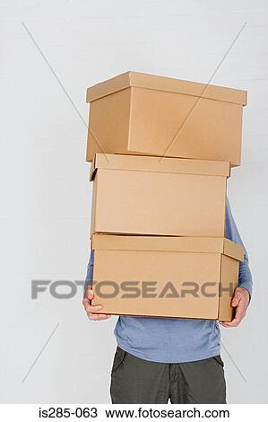 Man carrying cardboard boxes View Large Photo Image Stock Image - Man carrying cardboard boxes. Fotosearch