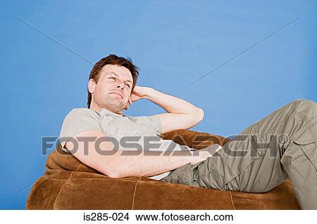 Man relaxing on a beanbag View Large Photo Image Picture - Man relaxing on a beanbag. Fotosearch