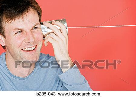 Man with tin can phone View Large Photo Image Stock Image - Man with tin can phone. Fotosearch