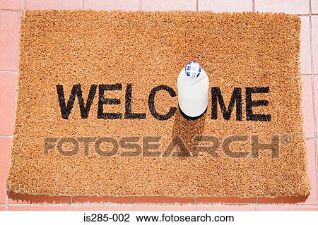 Stock Image - Milk bottle on a welcome mat. Fotosearch