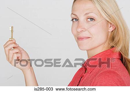 Woman holding a key View Large Photo Image Stock Image - Woman holding a key. Fotosearch