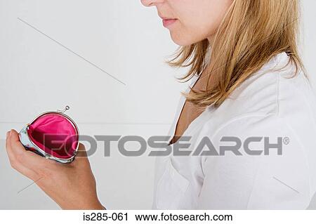 Stock Image - Woman holding empty purse. Fotosearch