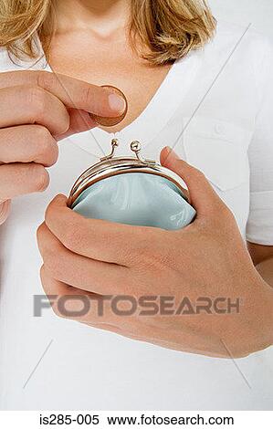 Woman putting coin into purse View Large Photo Image Stock Photography - Woman putting coin into purse. Fotosearch