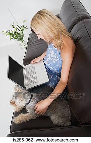 Woman with laptop and pet dog View Large Photo Image Stock Image - Woman with laptop and pet dog. Fotosearch