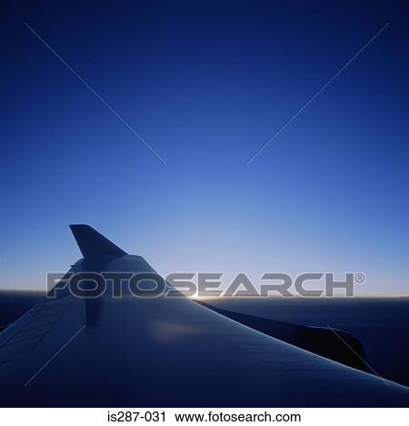 Aeroplane wing at sunrise View Large Photo Image Stock Image - Aeroplane wing at sunrise. Fotosearch