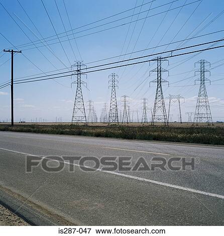 Pylons and power lines by a road View Large Photo Image Stock Photo - Pylons and power lines by a road. Fotosearch