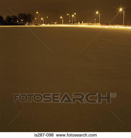 Snow covered ground in the evening View Large Photo Image Stock Photo - Snow covered ground in the evening. Fotosearch