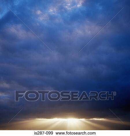 Stock Photo - Sunlight breaking though the clouds. Fotosearch