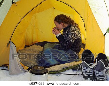 Female skier having a drink in a tent View Large Photo Image Stock Photograph - Female skier having a drink in a tent. Fotosearch