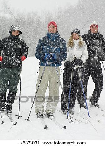 Stock Image - Four friends on skis. Fotosearch