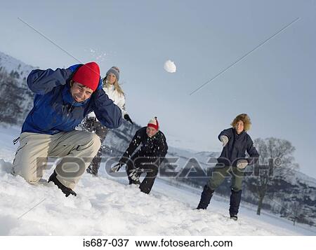 Stock Photo - Friends throwing snowballs. Fotosearch