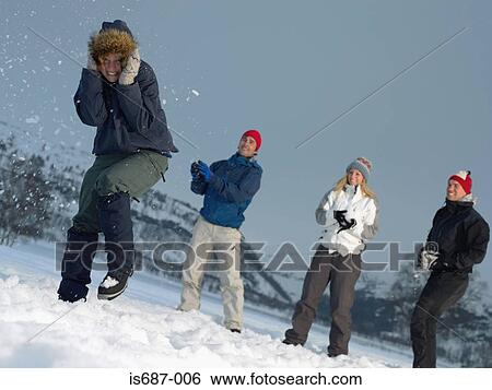 Friends throwing snowballs View Large Photo Image Stock Photograph - Friends throwing snowballs. Fotosearch
