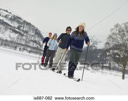 Friends trekking through the snow View Large Photo Image Stock Image - Friends trekking through the snow. Fotosearch
