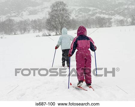 Girls on skis trekking through the snow View Large Photo Image Stock Image - Girls on skis trekking through the snow. Fotosearch
