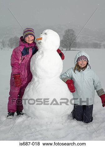 Stock Photo - Girls with snowman. Fotosearch