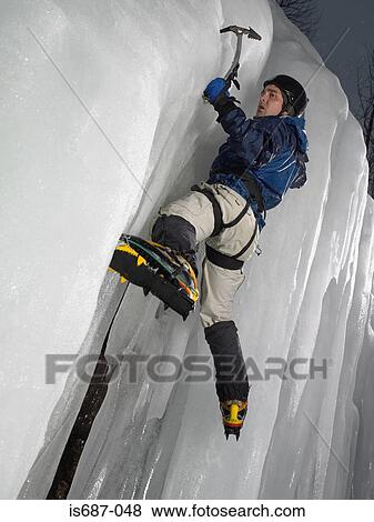 Stock Photo - Man ice climbing. Fotosearch