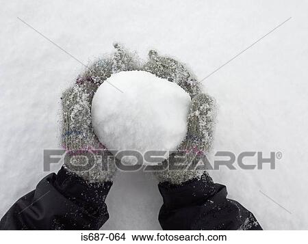 Picture - Person holding a snowball. Fotosearch