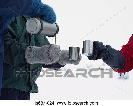 Pouring a warm drink View Large Photo Image Picture - Pouring a warm drink. Fotosearch