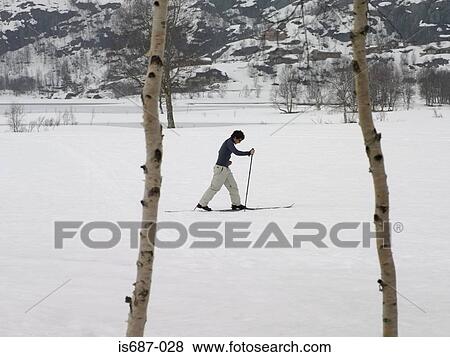 Skier trekking through snow View Large Photo Image Stock Photo - Skier trekking through snow. Fotosearch