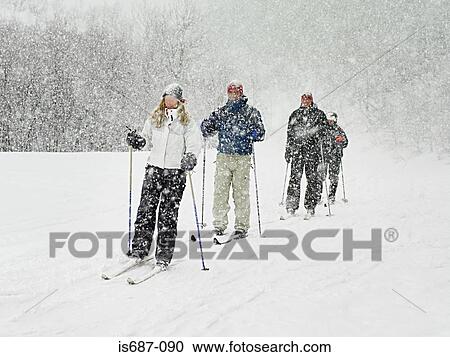 Stock Image - Skiers trekking through a blizzard. Fotosearch