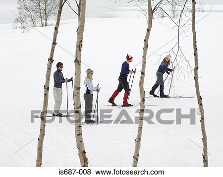 Skiers trekking through the snow View Large Photo Image Stock Photo - Skiers trekking through the snow. Fotosearch