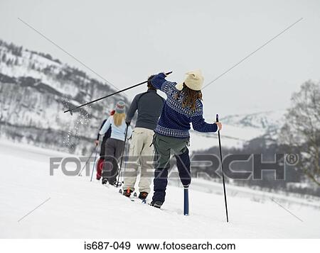 Stock Photo - Skiers walking through the snow. Fotosearch