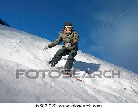 Stock Image - Woman snowboarding. Fotosearch