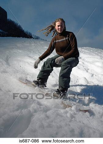 Stock Photograph - Woman snowboarding. Fotosearch