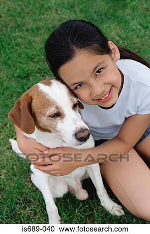 Girl hugging her pet dog View Large Photo Image Stock Image - Girl hugging her pet dog. Fotosearch