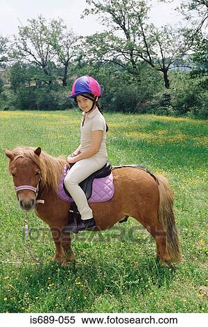 Stock Photography - Girl on a pony. Fotosearch