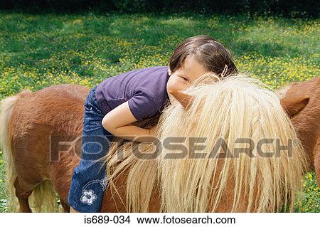Girl sitting on a pony View Large Photo Image Picture - Girl sitting on a pony. Fotosearch