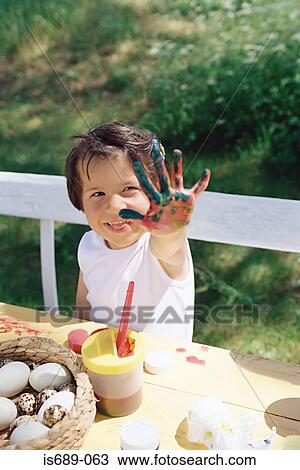 Stock Image - Girl with paint on her hands. Fotosearch