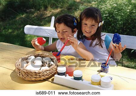 Girls painting eggs View Large Photo Image Stock Image - Girls painting eggs. Fotosearch