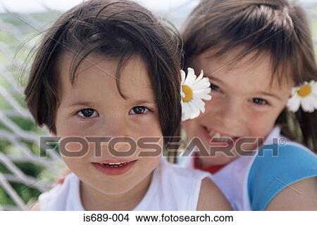 Girls with flowers in their hair View Large Photo Image Picture - Girls with flowers in their hair. Fotosearch