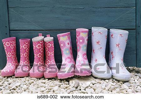 Stock Image - Row of rubber boots. Fotosearch