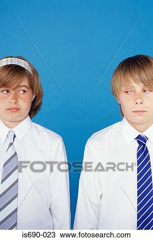 Boy and girl looking at each other suspiciously View Large Photo Image Stock Image - Boy and girl looking at each other suspiciously. Fotosearch