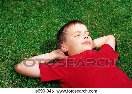 Boy asleep on the grass View Large Photo Image Stock Photography - Boy asleep on the grass. Fotosearch
