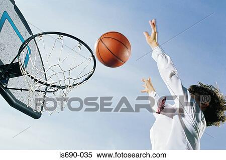 Stock Photography - Boy playing basketball. Fotosearch