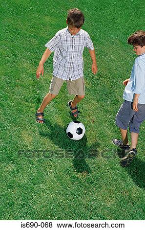 Boys playing football View Large Photo Image Stock Photo - Boys playing football. Fotosearch