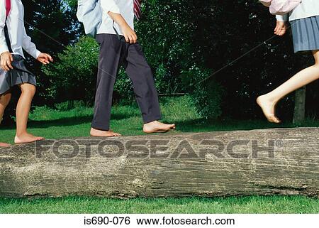 Children running along a log View Large Photo Image Stock Photograph - Children running along a log. Fotosearch