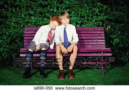Friends sitting on a park bench View Large Photo Image Stock Image - Friends sitting on a park bench. Fotosearch