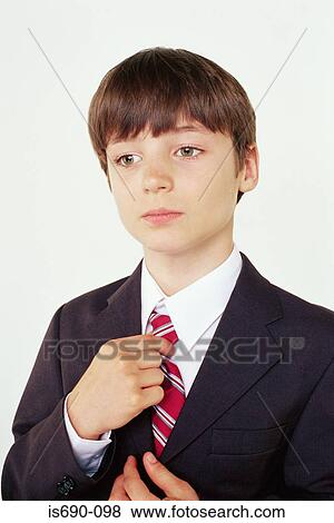 Schoolboy adjusting his tie View Large Photo Image Stock Photo - Schoolboy adjusting his tie. Fotosearch