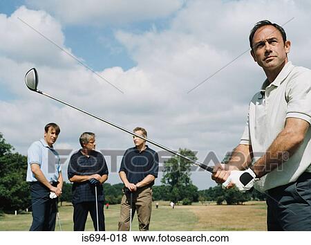 Stock Photo - Men playing golf. Fotosearch