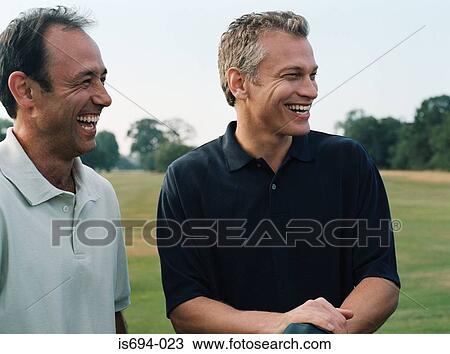 Stock Image - Two golfers laughing. Fotosearch