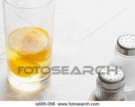 Stock Photograph - Egg yolks in a drinking glass. Fotosearch