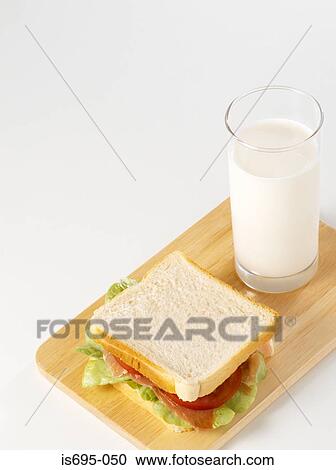 Ham sandwich and a glass of milk View Large Photo Image Stock Image - Ham sandwich and a glass of milk. Fotosearch