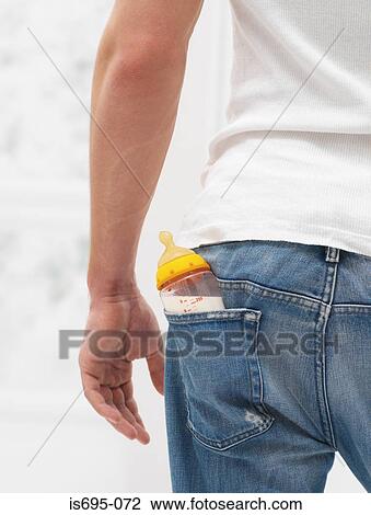 Man with a babies bottle in pocket View Large Photo Image Stock Image - Man with a babies bottle in pocket. Fotosearch