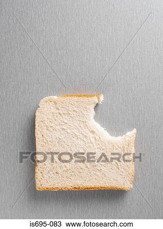 Stock Image - Missing bite from a slice of bread. Fotosearch