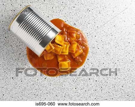 Stock Image - Ravioli spilling from tin can. Fotosearch