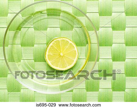 Stock Photo - Slice of lemon on a glass plate. Fotosearch